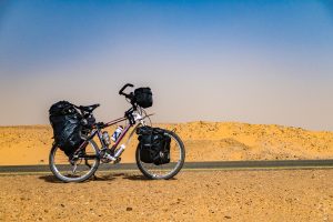 Cycling in Sahara from Dongola to Karima in Sudan against strong winds,