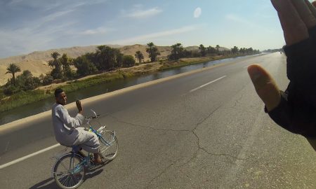 Cyclcing along a canal near Nile river in Egypt.
