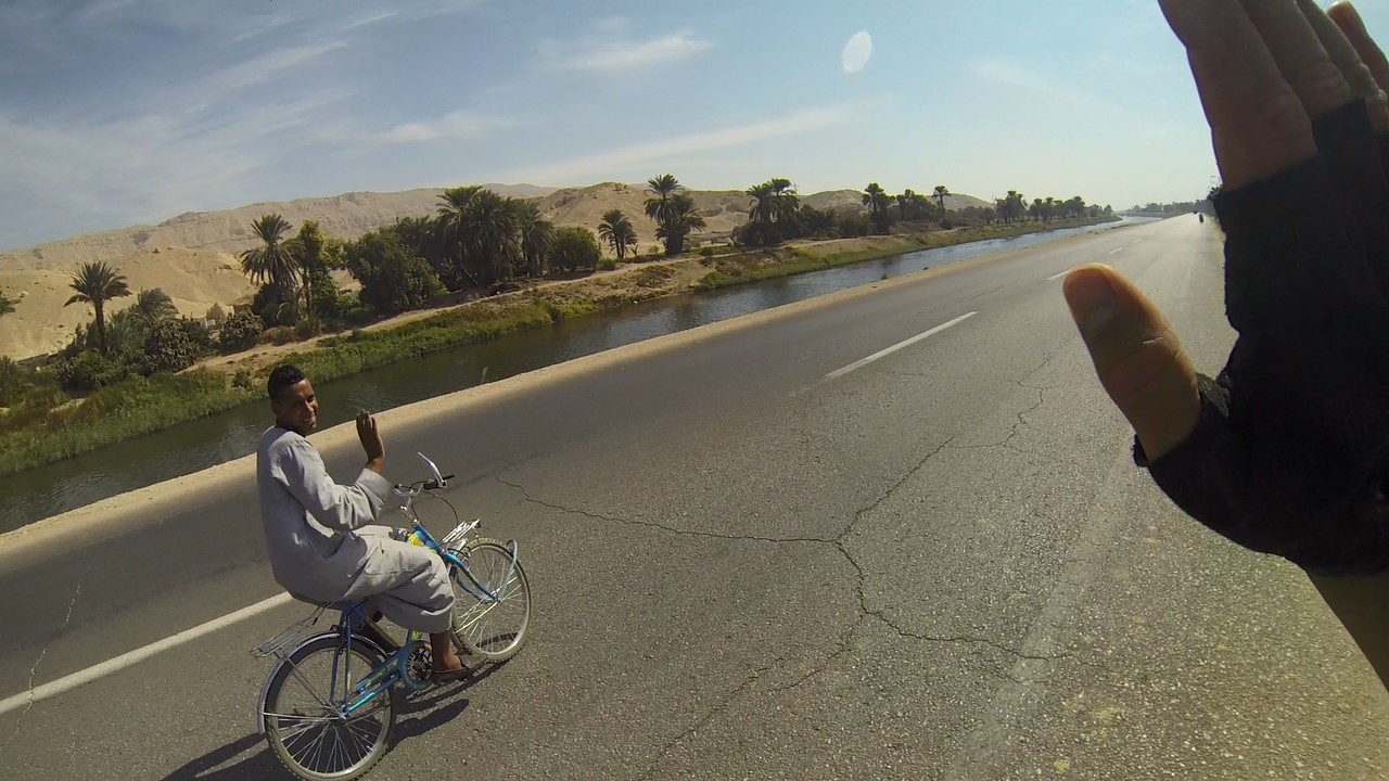 Cyclcing along a canal near Nile river in Egypt.